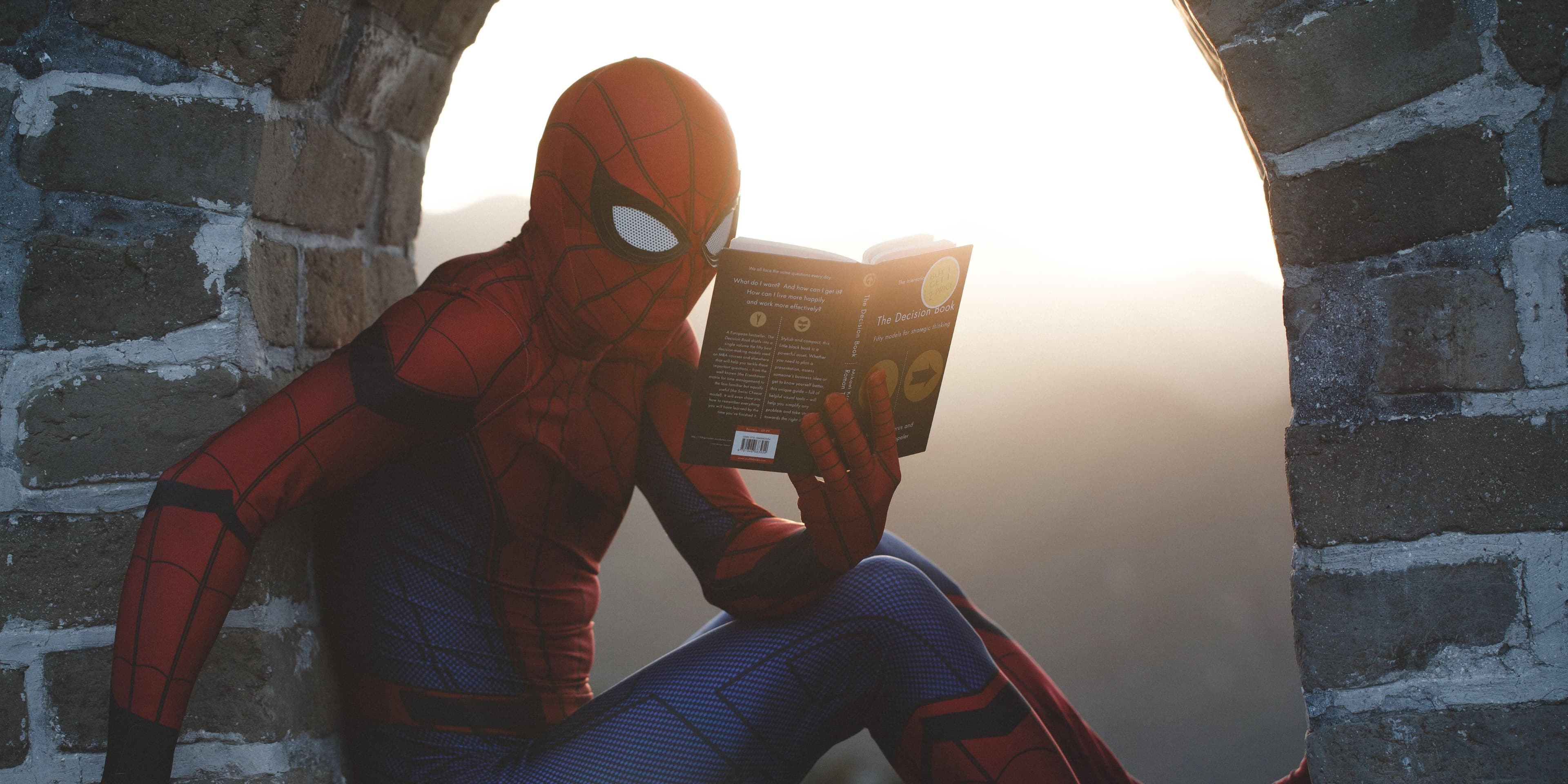 spiderman reading a book by @roadtripwithraj on Unsplash